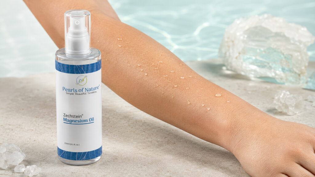 Zechstein Magnesium Oil beside mineral droplets resting on healthy intact forearm skin.